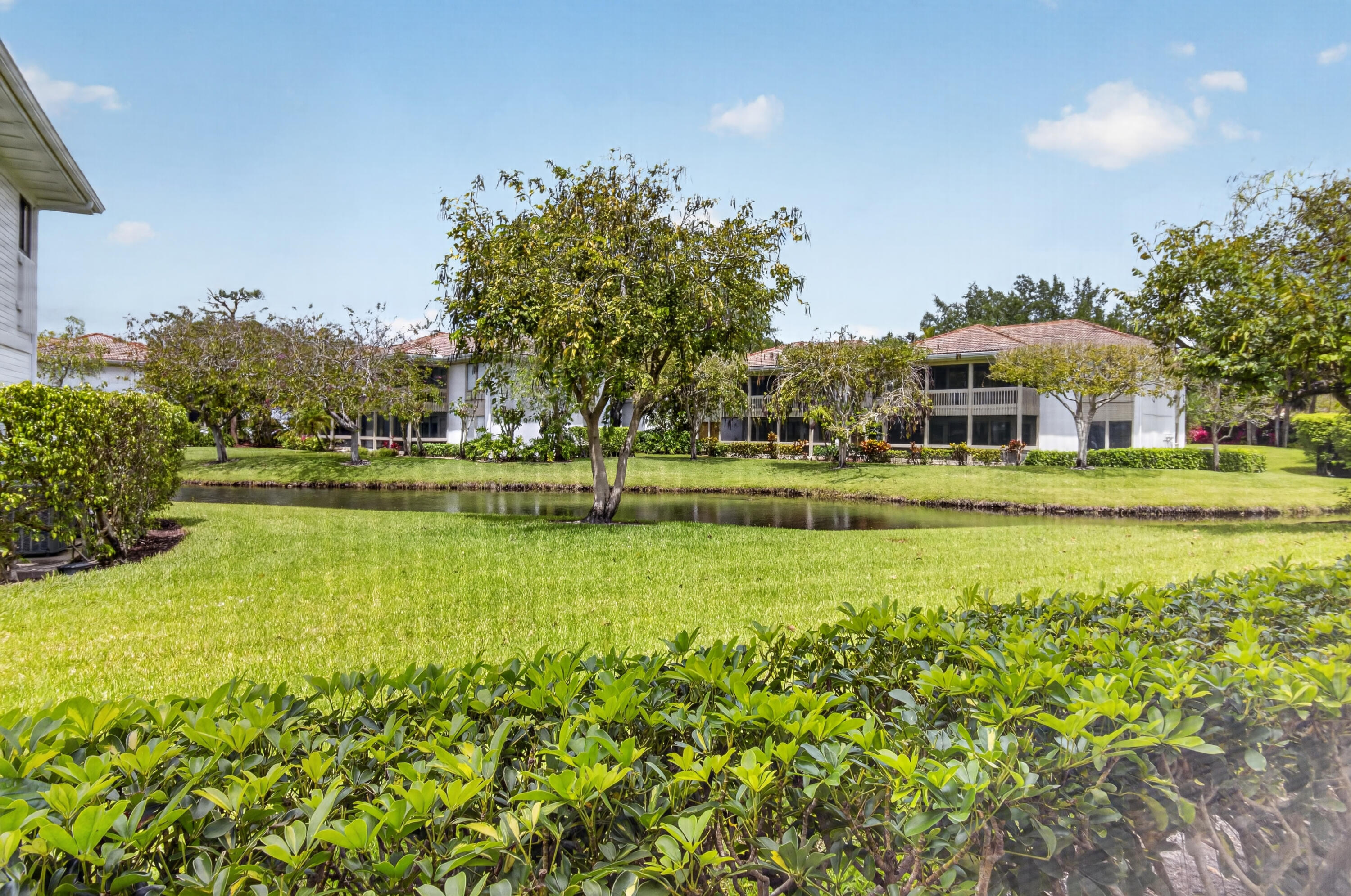 19981 Boca W Drive, Unit 3123 Boca Raton, FL 33434 - Photo 26 of 57 a view of a swimming pool with an outdoor space and seating area