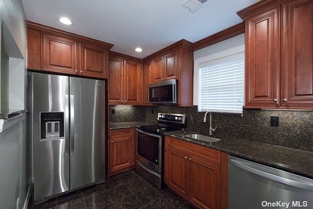 a kitchen with stainless steel appliances granite countertop a refrigerator stove a sink and dishwasher