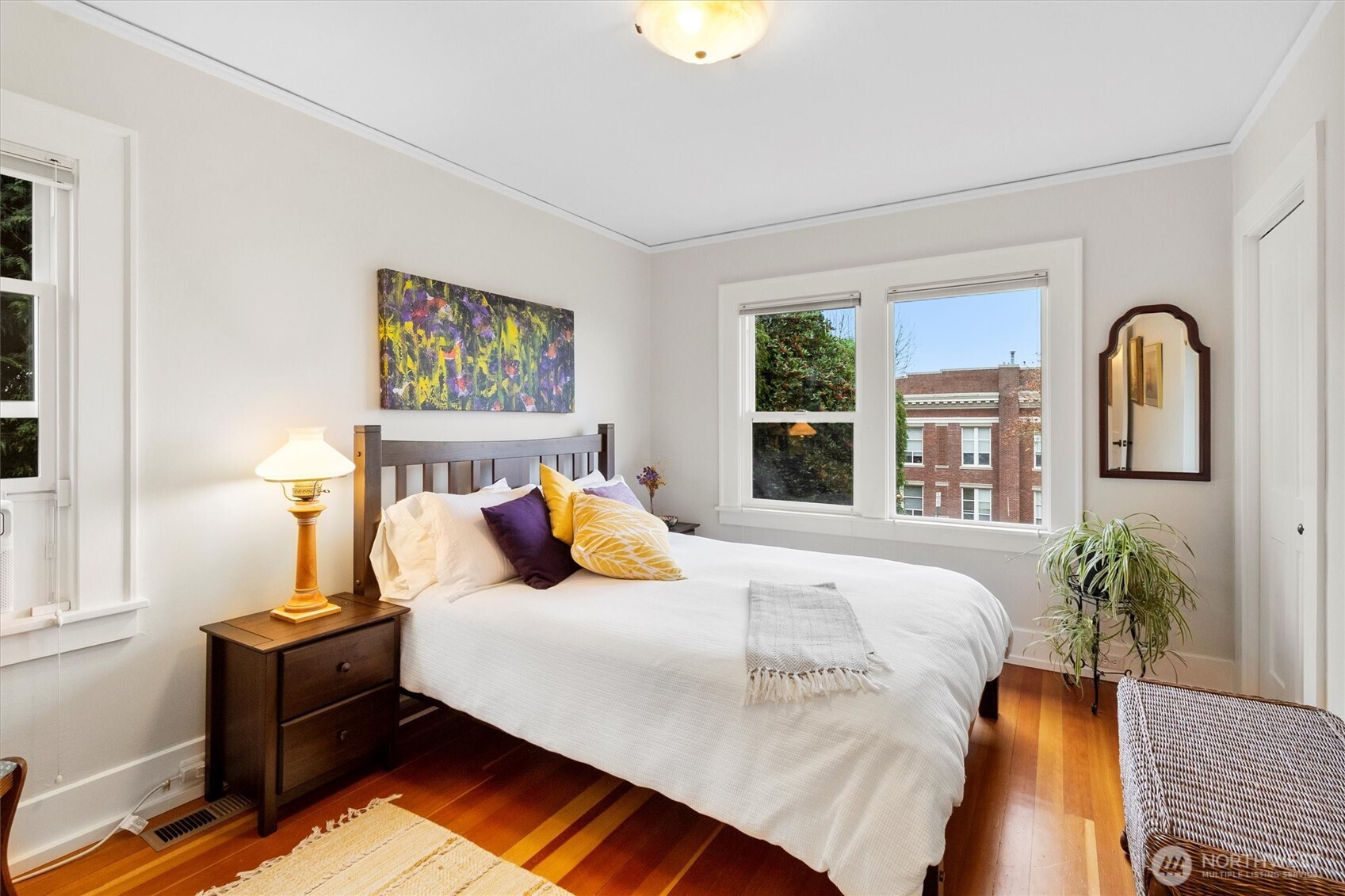 925 15th Street Bellingham, WA 98225 - Photo 14 of 40 a bedroom with bed and a potted plant next to a window