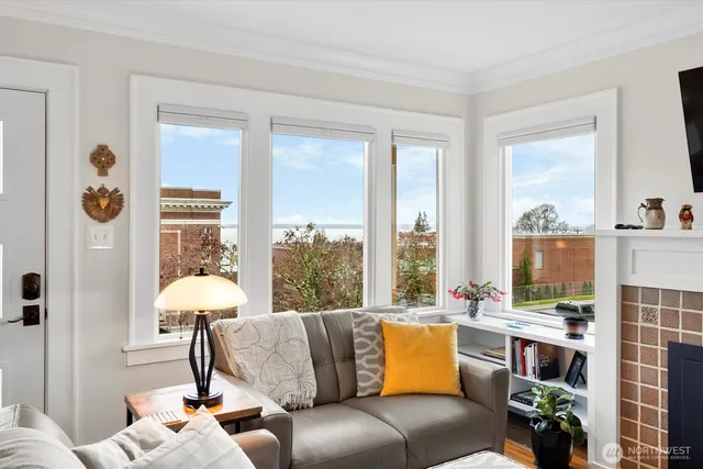 a living room with furniture and a floor to ceiling window