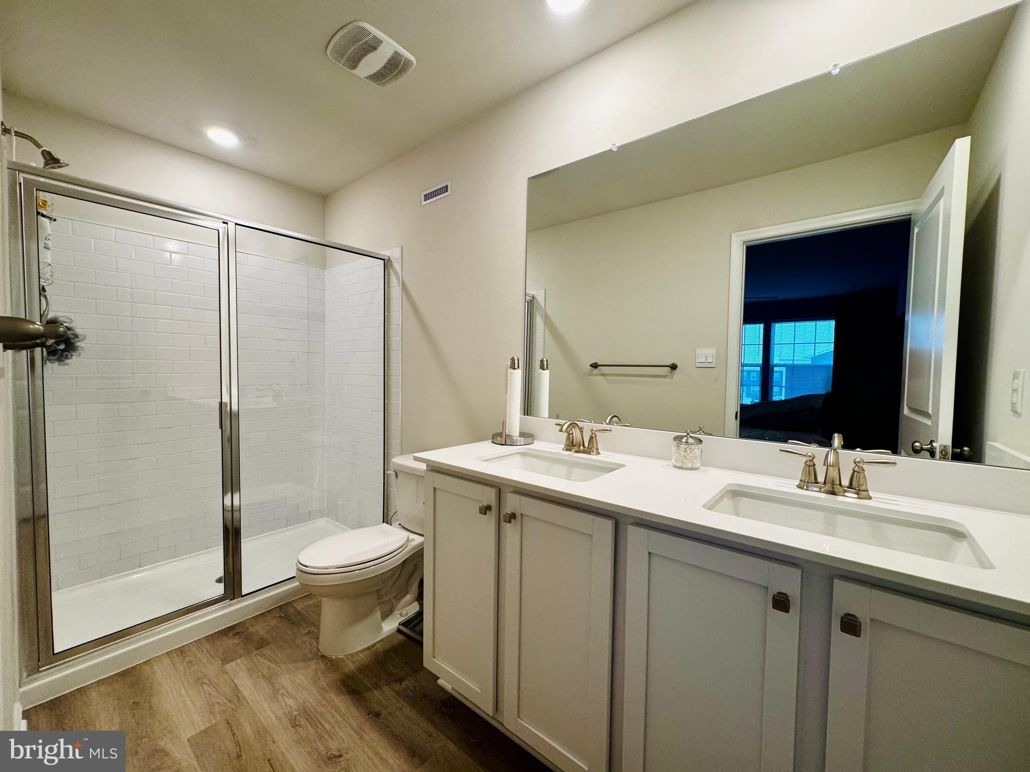 33 Alexander Way Westampton, NJ 08060 - Photo 11 of 18 a bathroom with a double vanity sink toilet mirror and shower