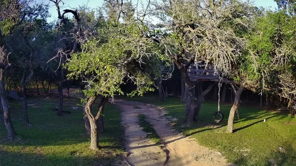 a backyard of a house with lots of green space