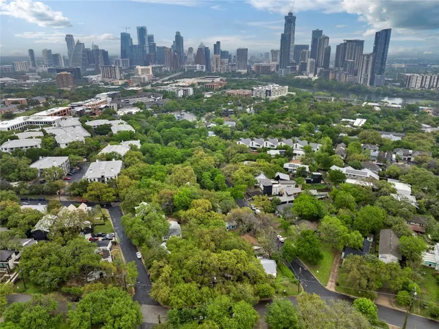 an aerial view of residential houses with city view