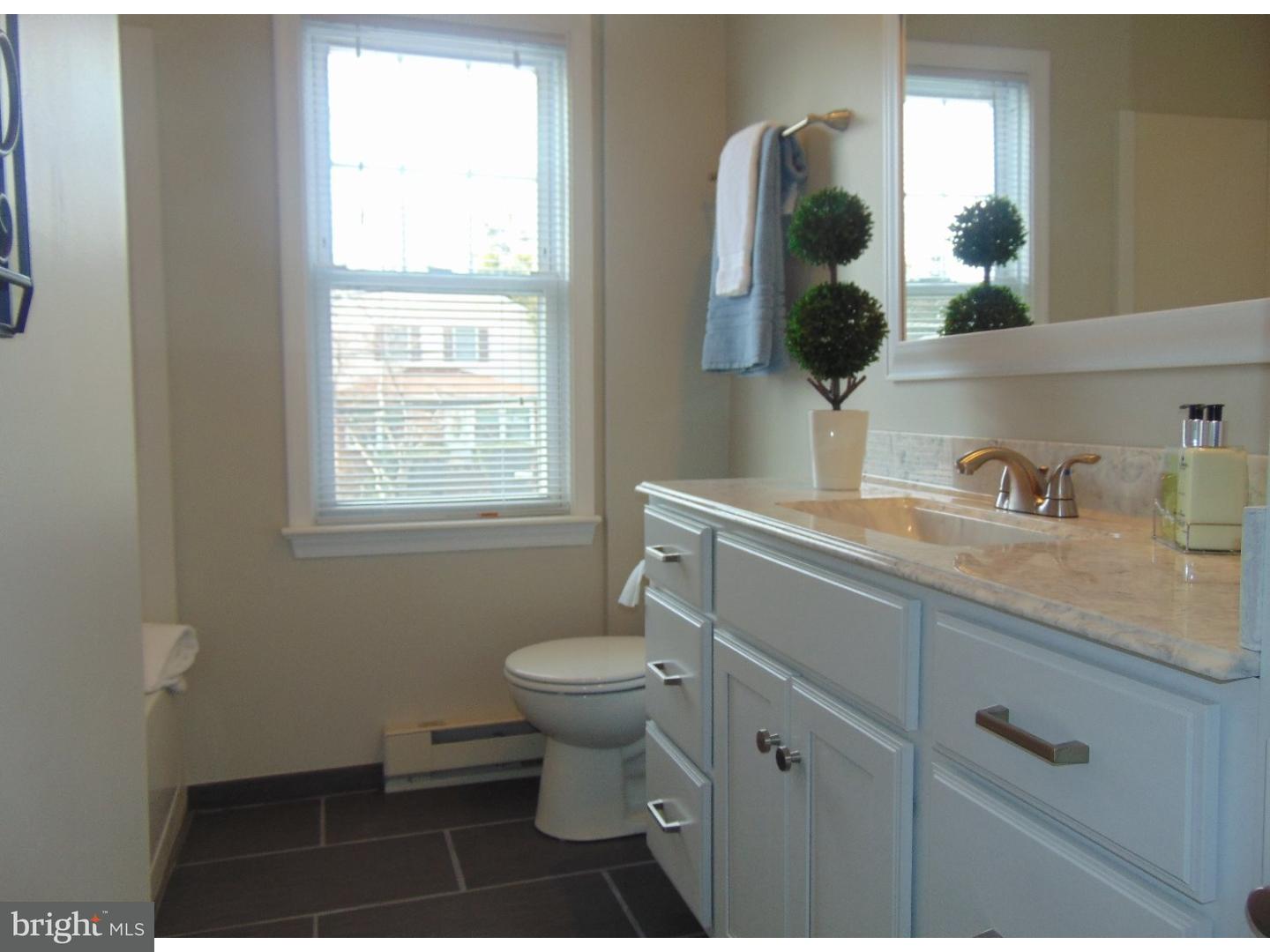 124 Ronald Road Aston, PA 19014 - Photo 14 of 25 a bathroom with a toilet sink and mirror