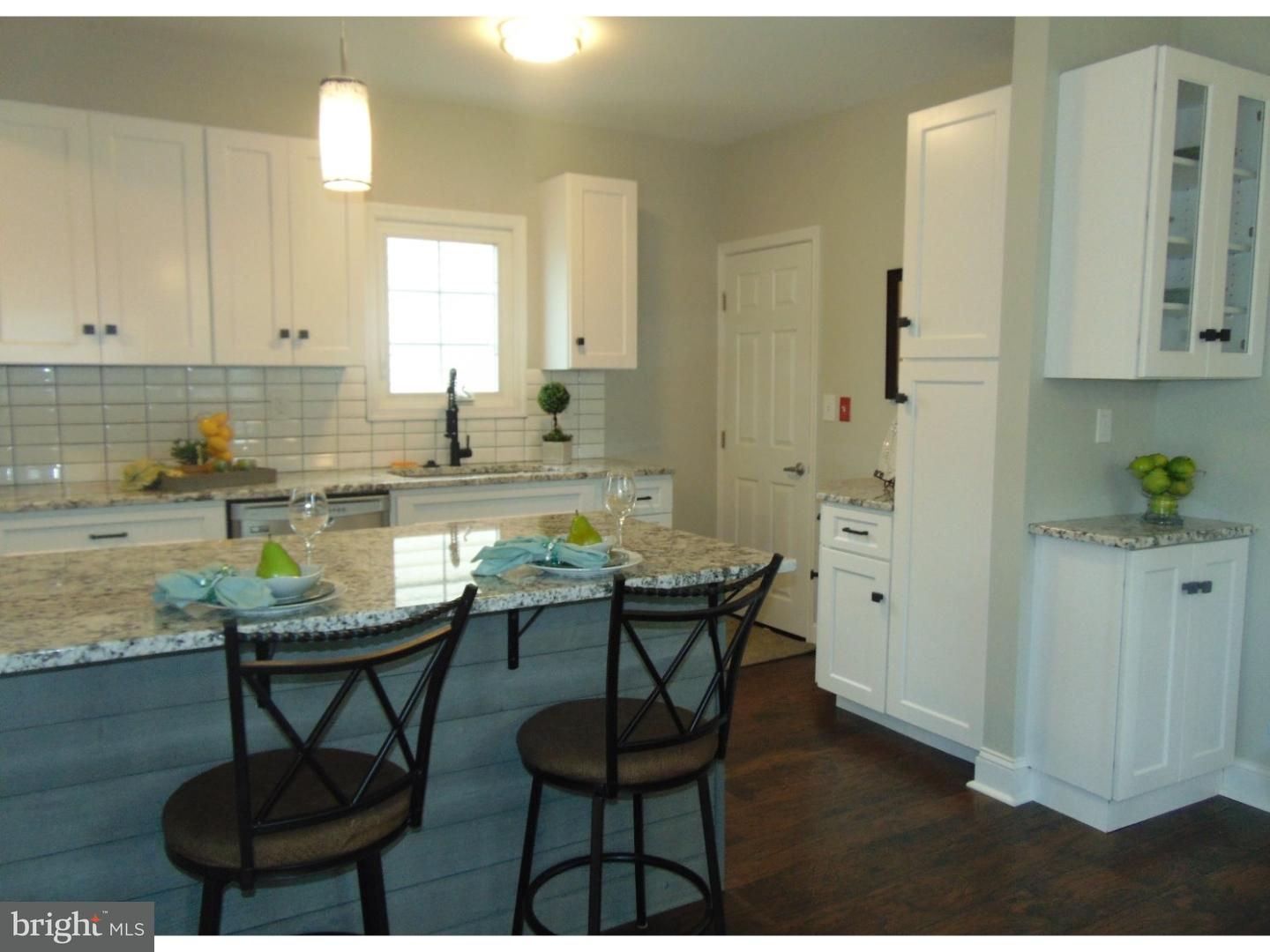 124 Ronald Road Aston, PA 19014 - Photo 3 of 25 a kitchen with stainless steel appliances a table and chairs in it