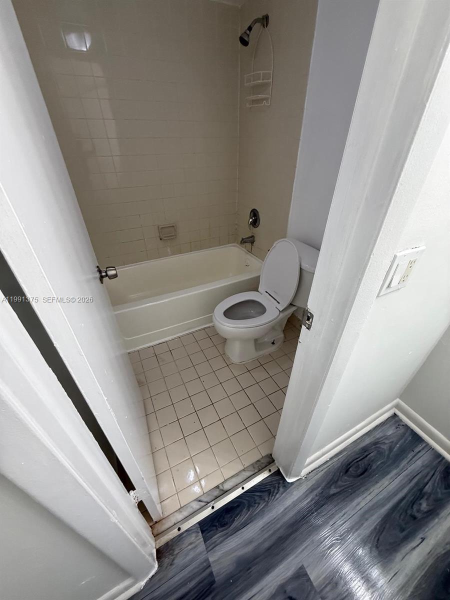 7210 Northwest 179th Street, Unit 203 Hialeah, FL 33015 - Photo 16 of 16 a bathroom with a sink and a bathtub