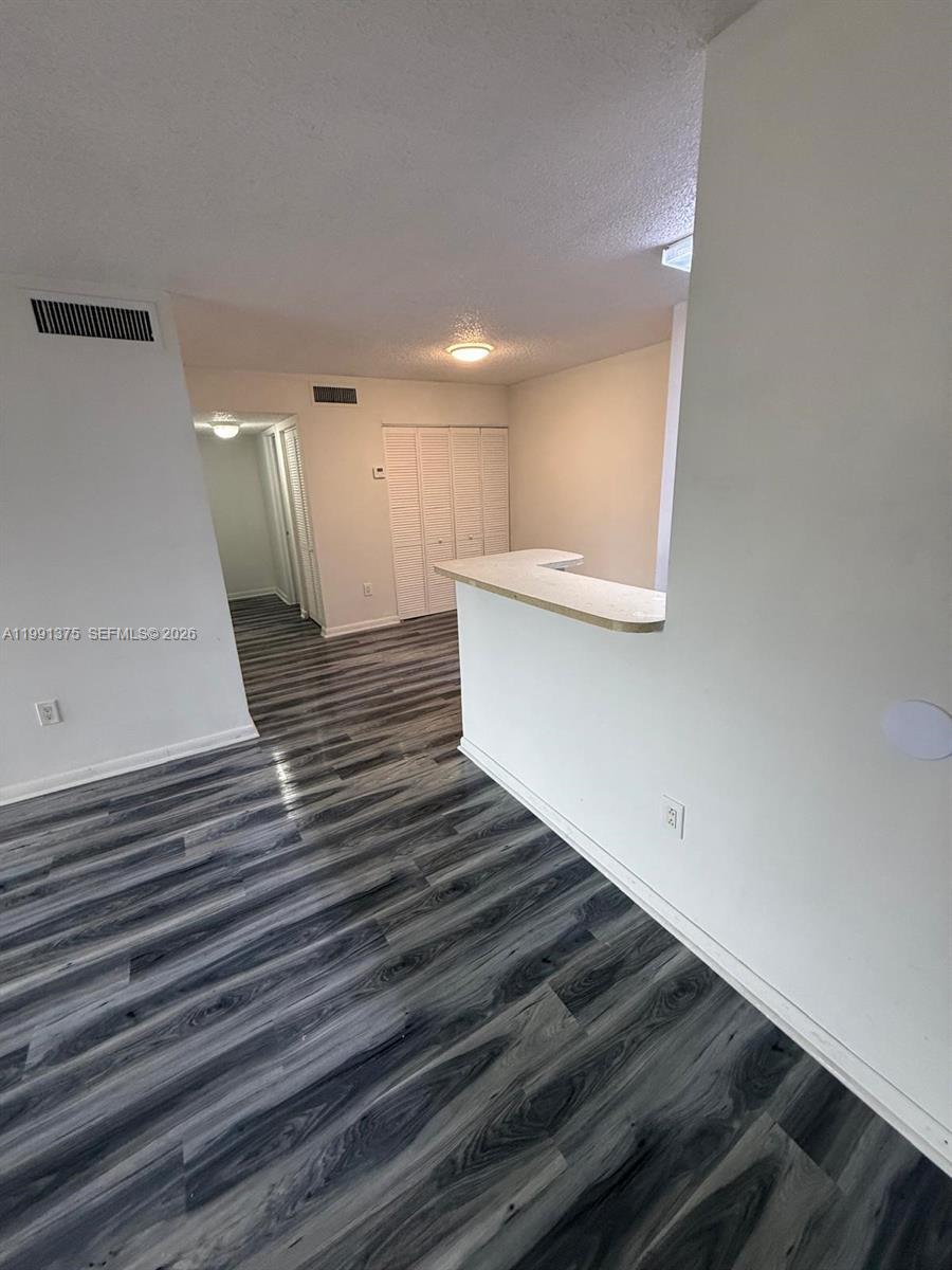 7210 Northwest 179th Street, Unit 203 Hialeah, FL 33015 - Photo 5 of 16 a view of a hallway with stairs and a couch