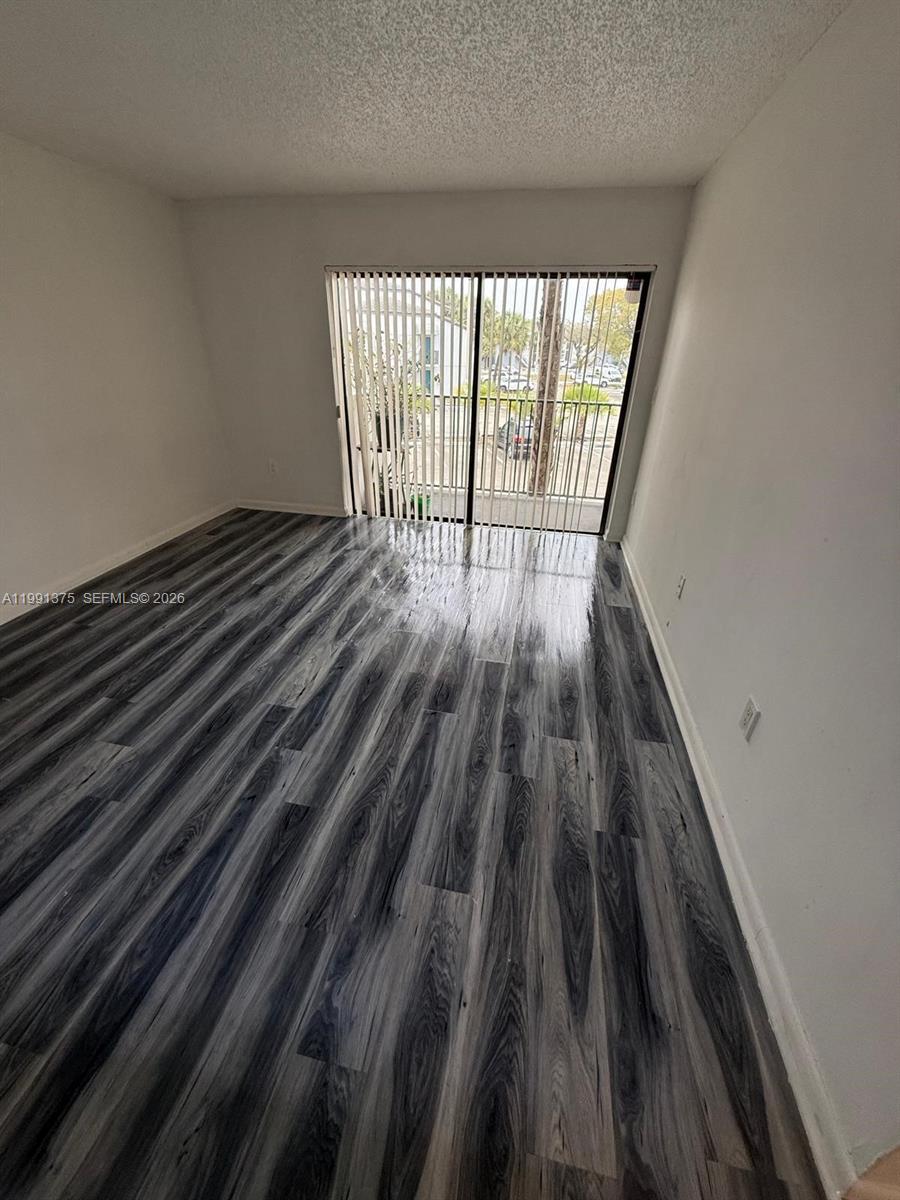 7210 Northwest 179th Street, Unit 203 Hialeah, FL 33015 - Photo 6 of 16 a view of wooden floor