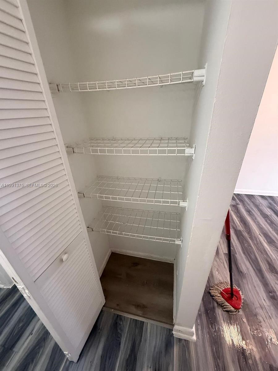 7210 Northwest 179th Street, Unit 203 Hialeah, FL 33015 - Photo 7 of 16 a view of walk in closet with clothes and shoes
