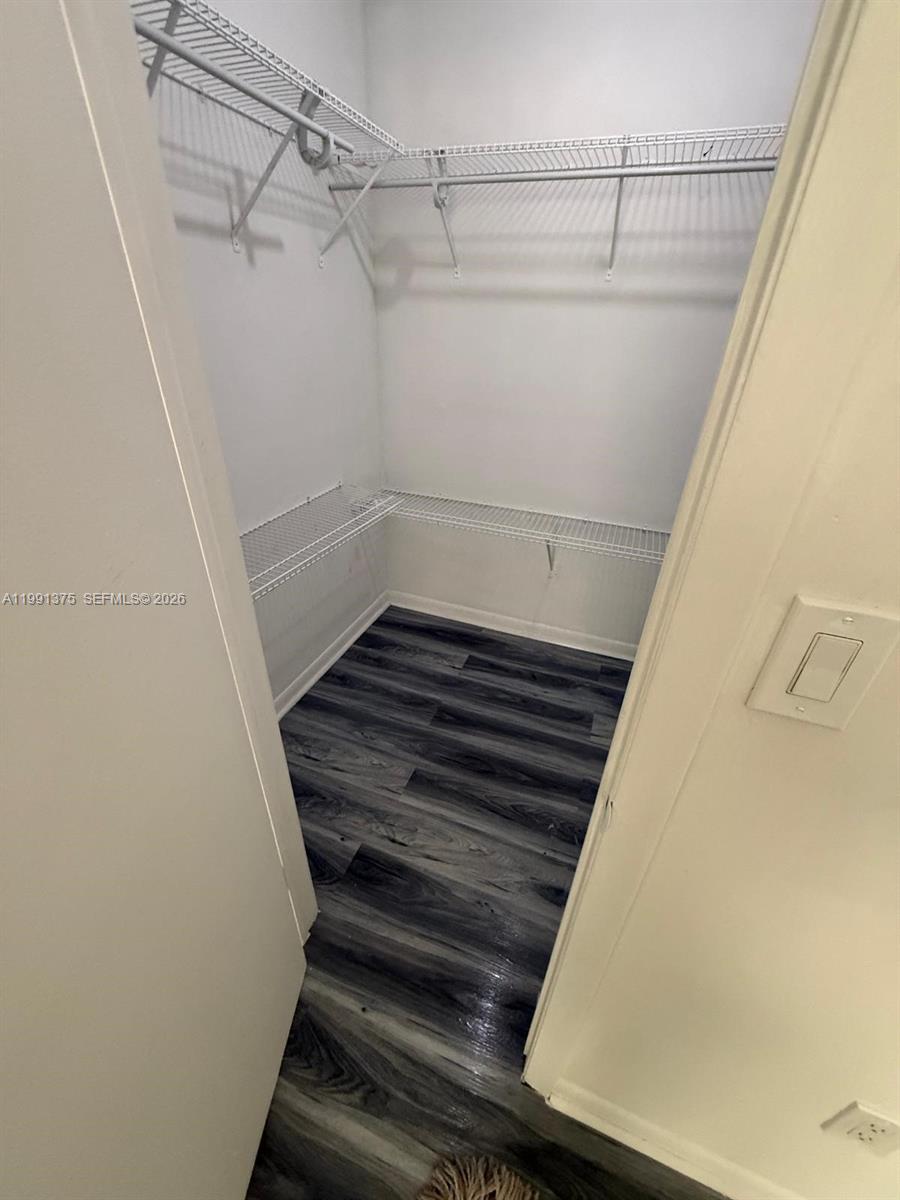 7210 Northwest 179th Street, Unit 203 Hialeah, FL 33015 - Photo 8 of 16 a view of a room with racks on the wall