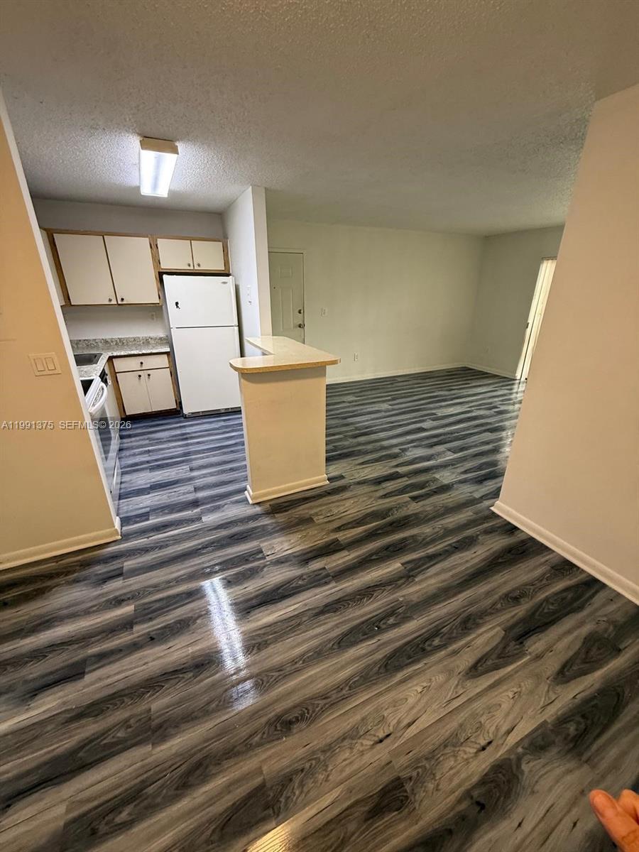 7210 Northwest 179th Street, Unit 203 Hialeah, FL 33015 - Photo 10 of 16 a view of kitchen and wooden floor