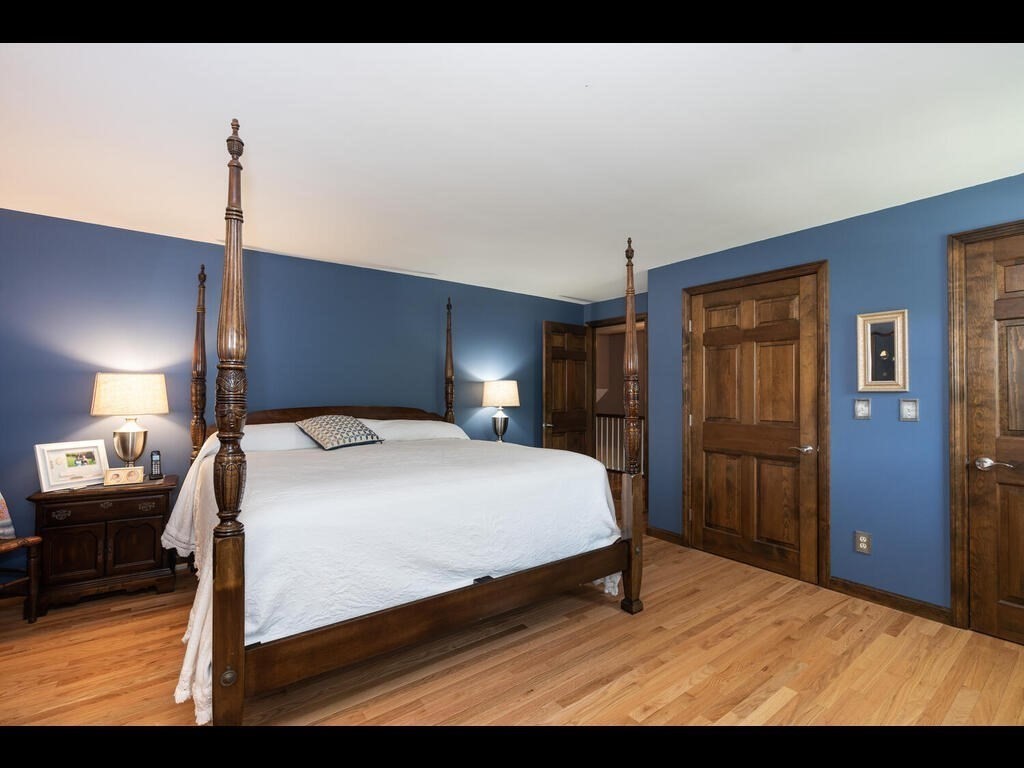 151 Ames Road Hampden, MA 01036 - Photo 26 of 41 a bedroom with a bed wooden floor and lamp