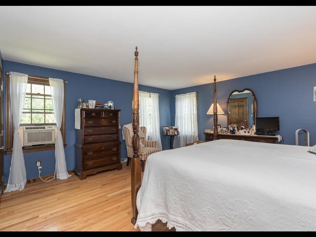 151 Ames Road Hampden, MA 01036 - Photo 28 of 41 a bedroom with a bed and wooden floor