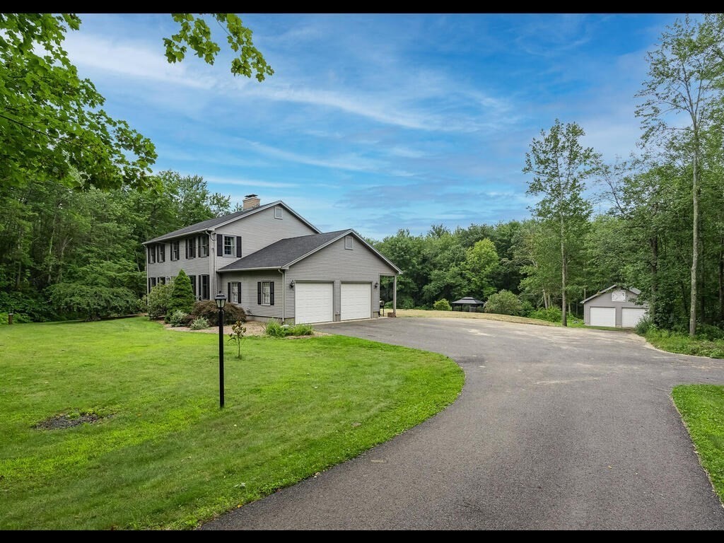 151 Ames Road Hampden, MA 01036 - Photo 3 of 41 a front view of a house with a garden