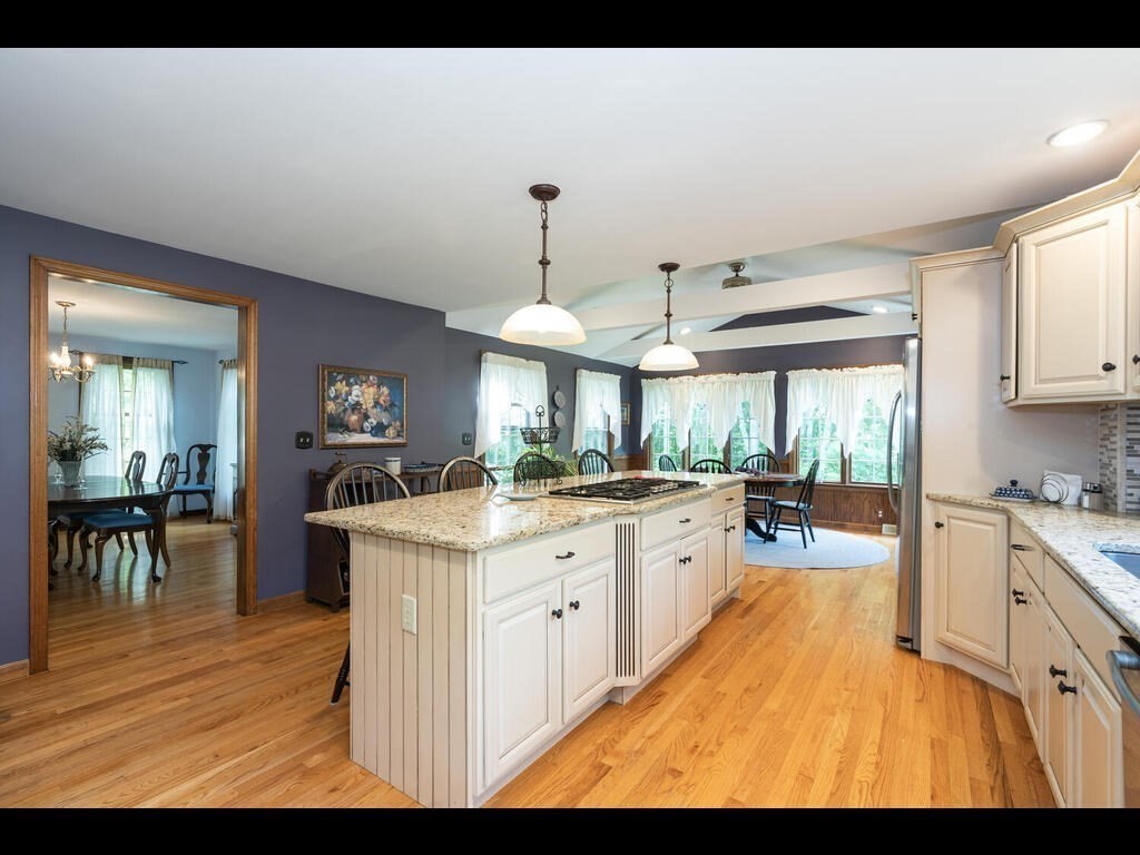 151 Ames Road Hampden, MA 01036 - Photo 6 of 41 a kitchen with kitchen island granite countertop a sink stove and cabinets