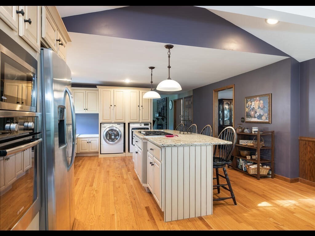 151 Ames Road Hampden, MA 01036 - Photo 10 of 41 a large kitchen with a table chairs and a wooden floor
