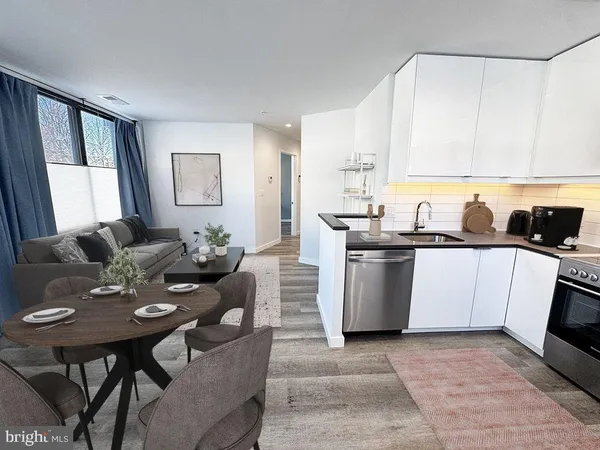 a kitchen with a table chairs microwave and cabinets