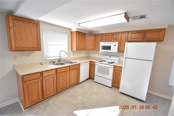 a kitchen with white cabinets and white appliances