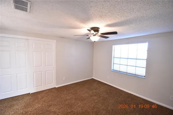 a view of an empty room with a window