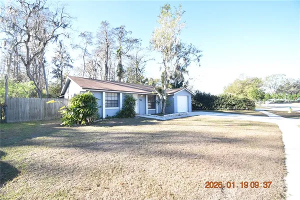a very nice looking house with a large trees
