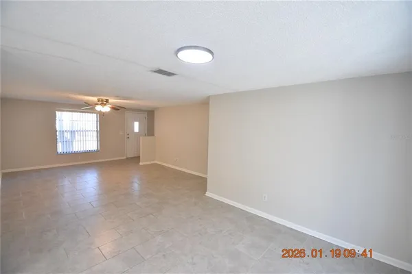 an empty room with windows and closet