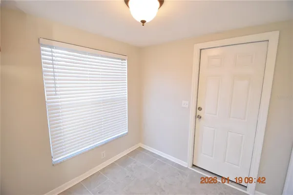 a view of an empty room with a window