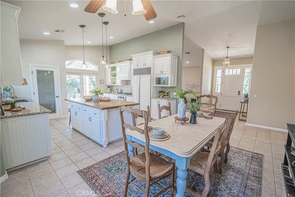 a kitchen with kitchen island granite countertop a sink stove and refrigerator