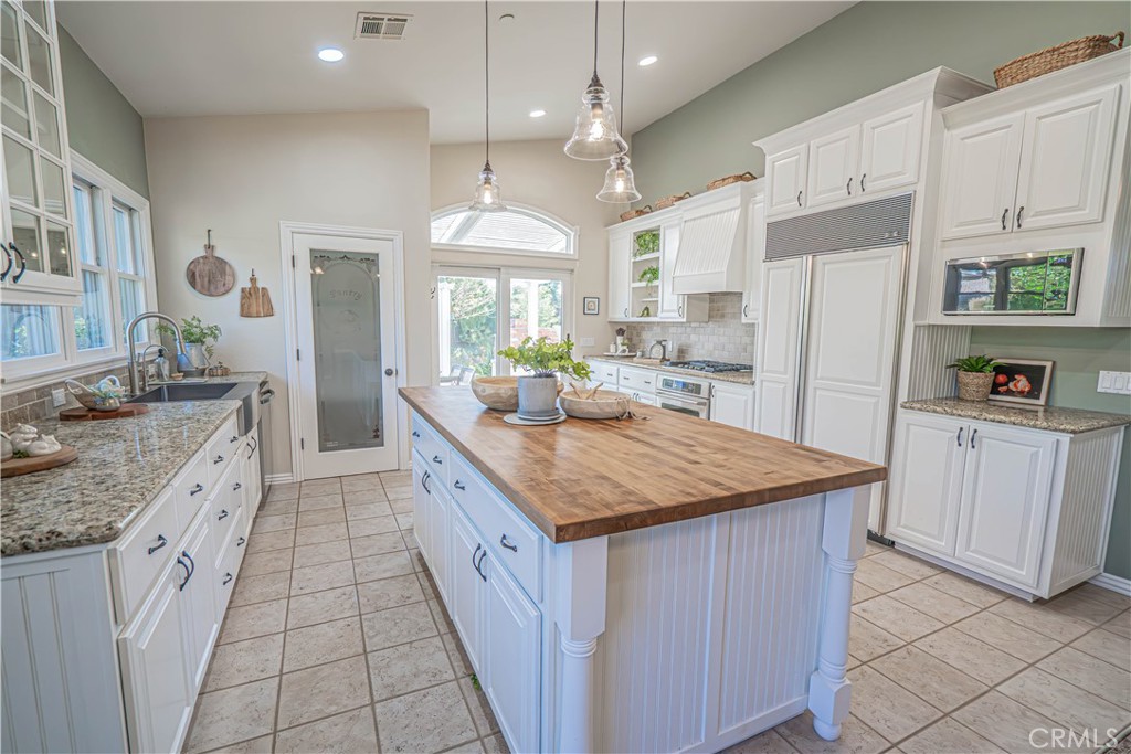 11340 Morgan Road Agua Dulce, CA 91390 - Photo 18 of 60 a kitchen with kitchen island granite countertop a sink stove and refrigerator