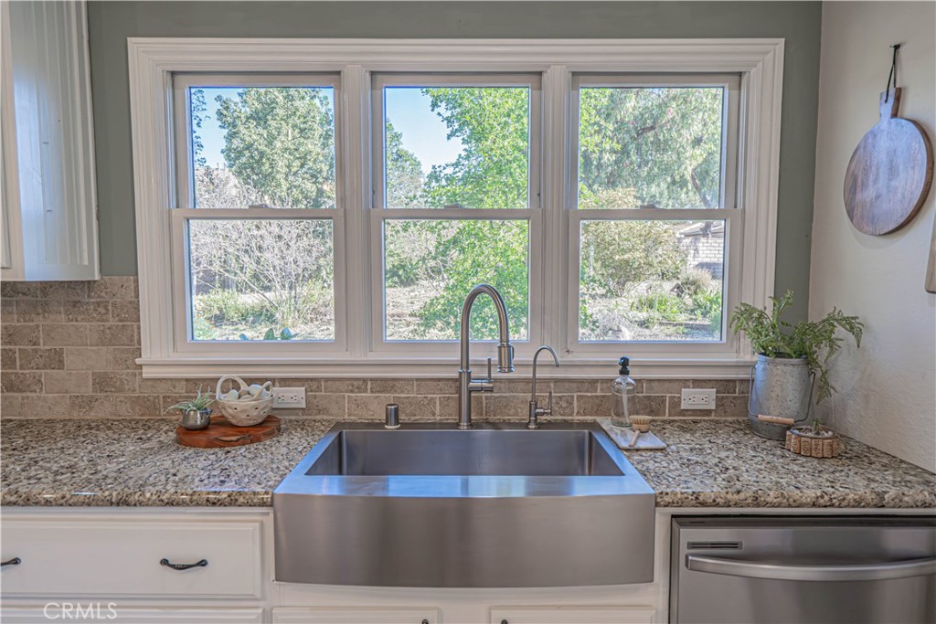11340 Morgan Road Agua Dulce, CA 91390 - Photo 20 of 60 a kitchen with granite countertop a sink a counter appliances and a window