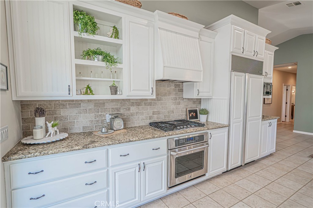 11340 Morgan Road Agua Dulce, CA 91390 - Photo 22 of 60 a kitchen with granite countertop white cabinets and white appliances