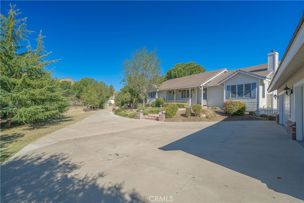 11340 Morgan Road Agua Dulce, CA 91390 - Photo 50 of 60 a front view of a house with a yard and potted plants