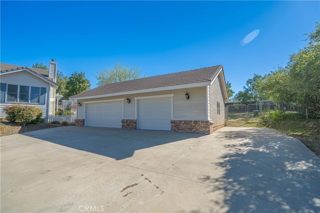 11340 Morgan Road Agua Dulce, CA 91390 - Photo 5 of 60 a front view of a house with a yard and garage