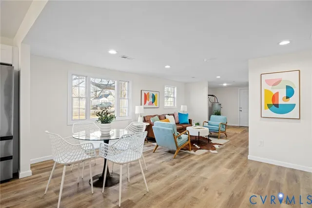 a living room with furniture and painting on the wall