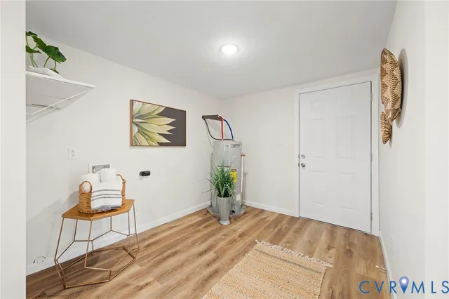 a bedroom with a bed and painting on the wall