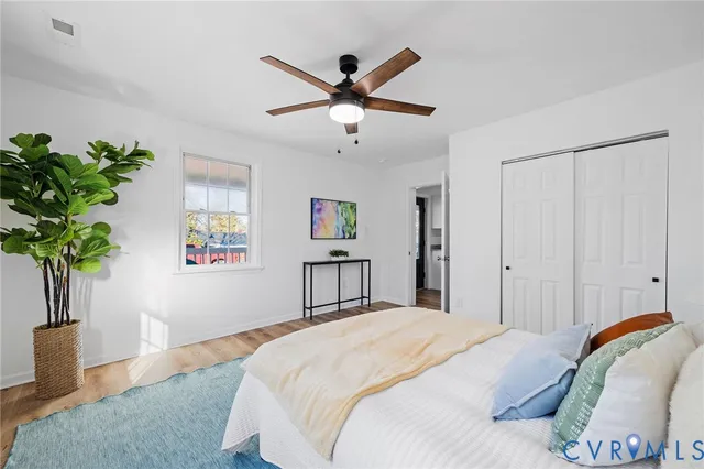a bedroom with a bed and a potted plant