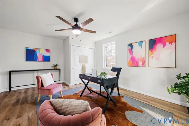 a living room with furniture and a potted plant