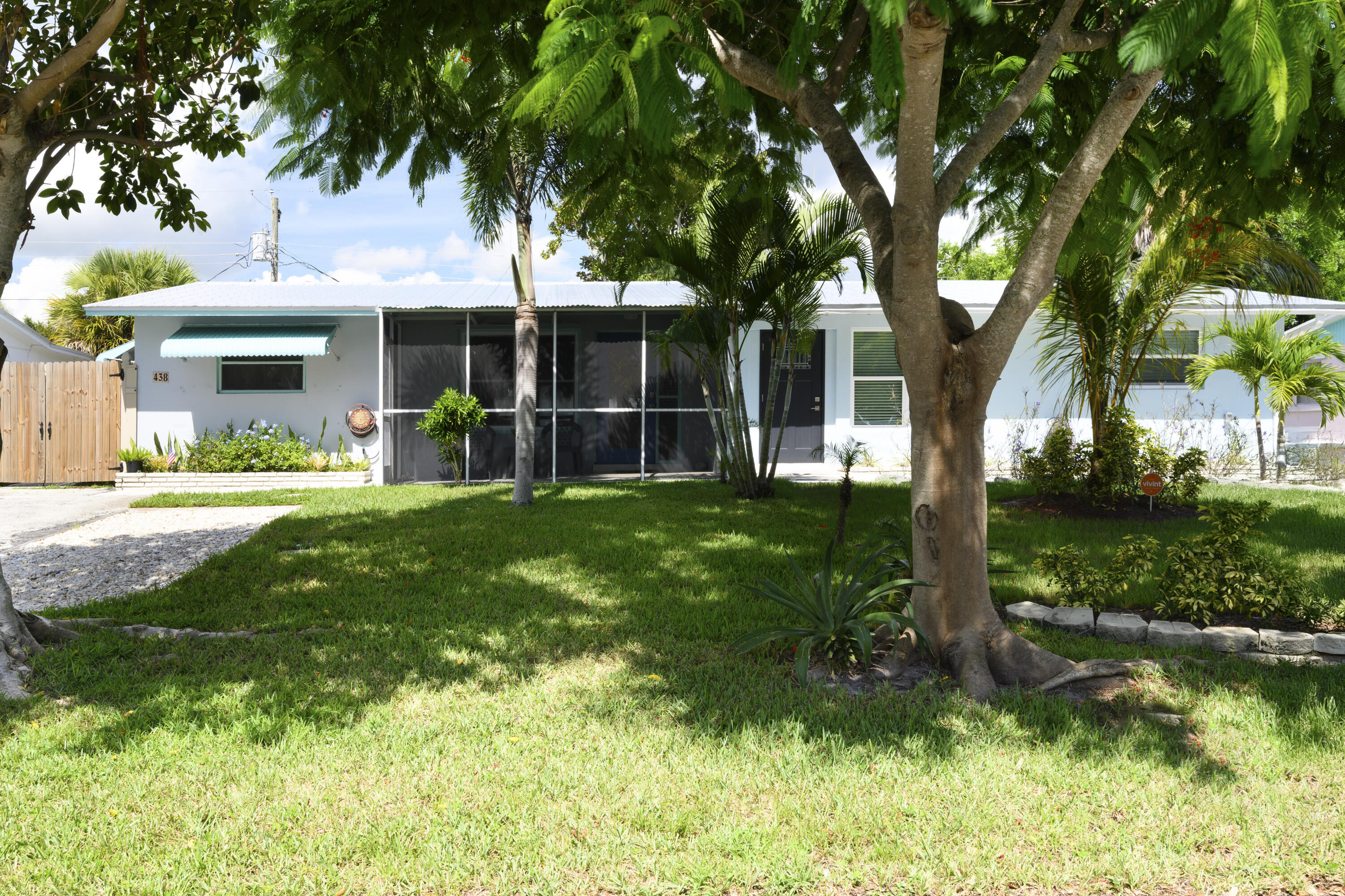438 Southeast Fini Drive Stuart, FL 34996 - Photo 1 of 21 a front view of a house with garden