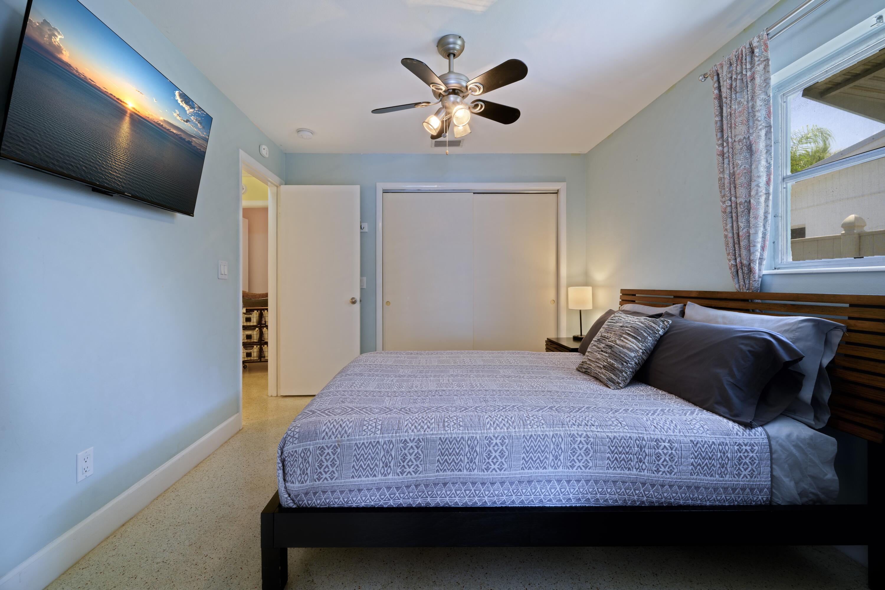 438 Southeast Fini Drive Stuart, FL 34996 - Photo 13 of 21 a bedroom with a bed and a flat tv screen on dresser