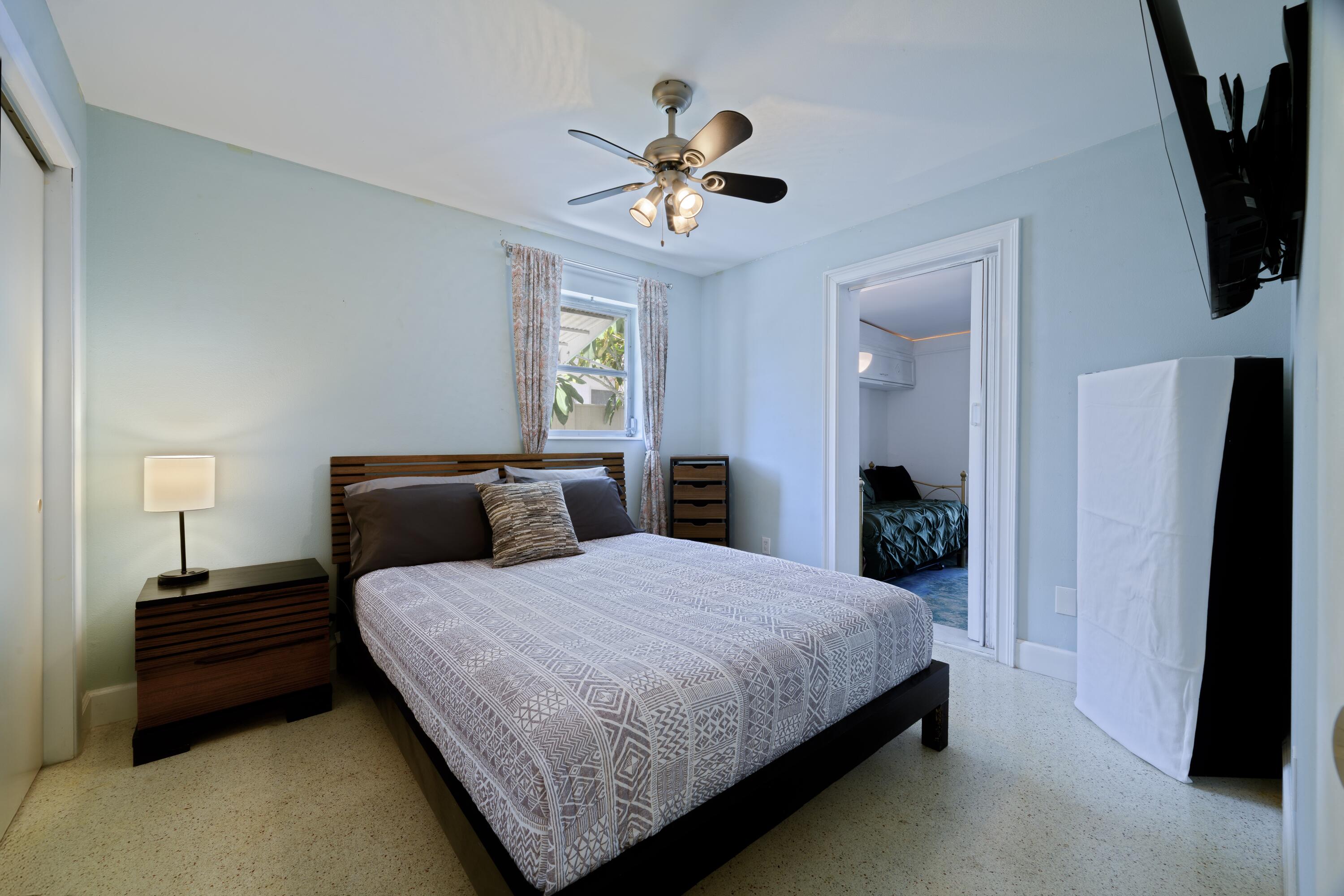 438 Southeast Fini Drive Stuart, FL 34996 - Photo 14 of 21 a bedroom with a bed and a chandelier