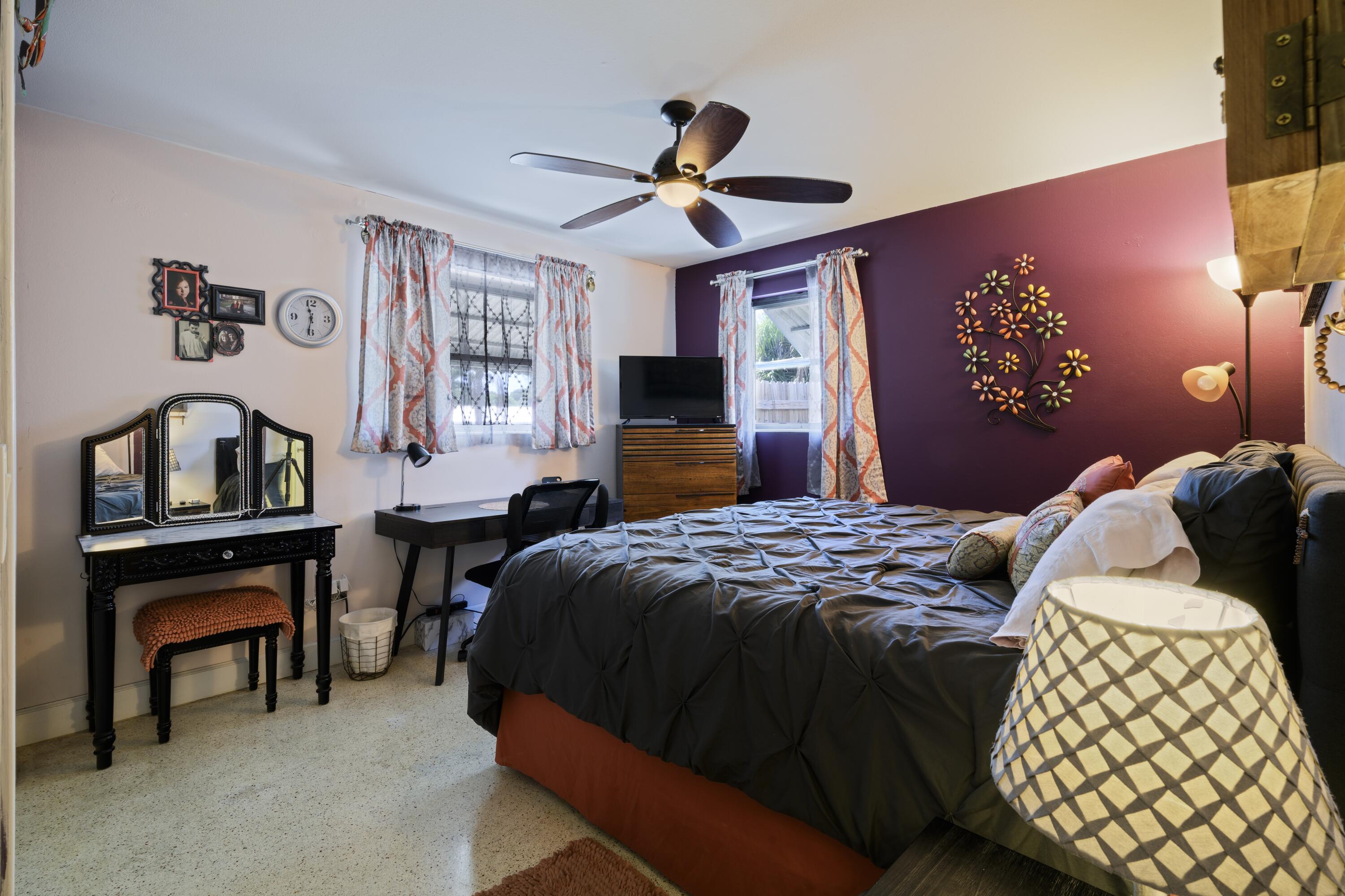 438 Southeast Fini Drive Stuart, FL 34996 - Photo 16 of 21 a bedroom with a bed and a chandelier
