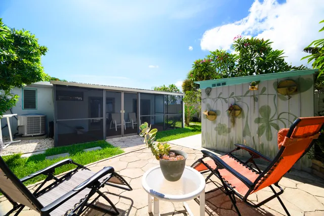 a view of a backyard with furniture and a backyard