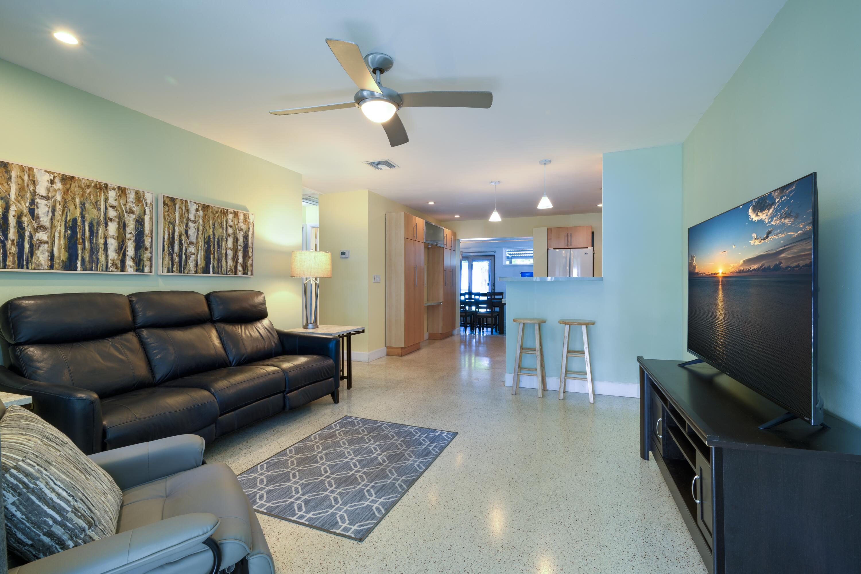 438 Southeast Fini Drive Stuart, FL 34996 - Photo 3 of 21 a living room with furniture and a flat screen tv