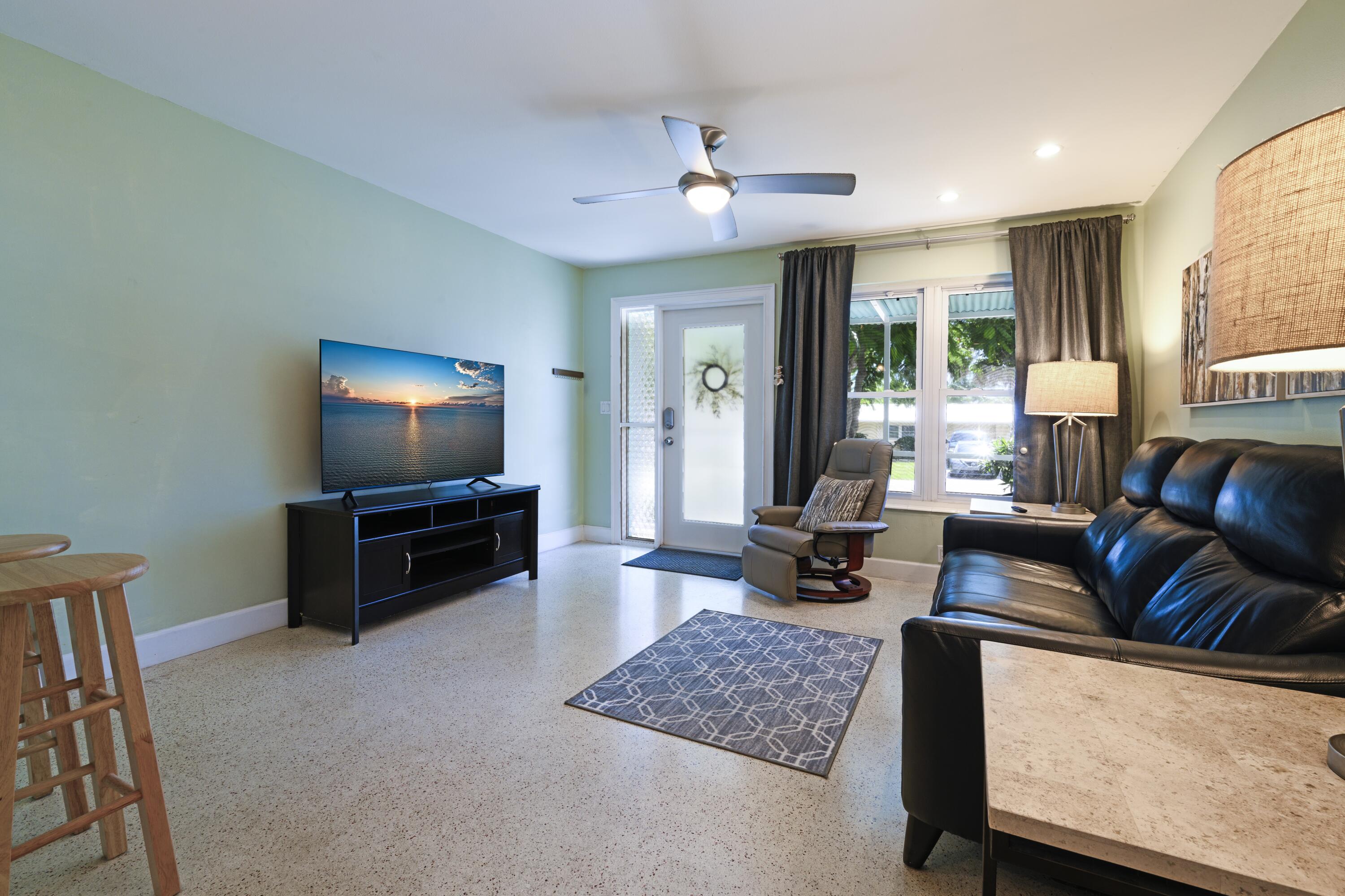 438 Southeast Fini Drive Stuart, FL 34996 - Photo 4 of 21 a living room with furniture and a flat screen tv