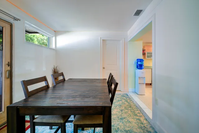 a view of a dining room with furniture and a window