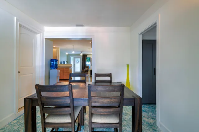 a dining room with furniture and wooden floor
