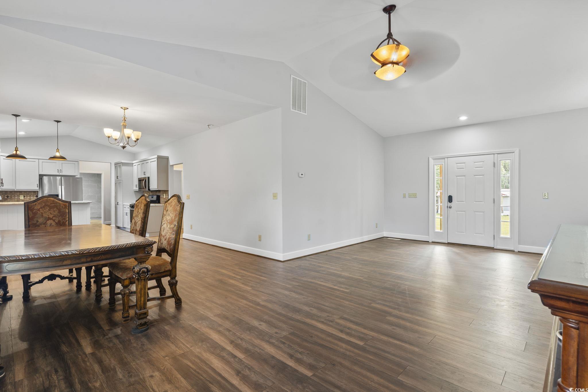 1585 Daisy Road Loris, SC 29569 - Photo 12 of 39 Dining area with vaulted ceiling, dark wood-style flooring, recessed lighting, and a chandelier