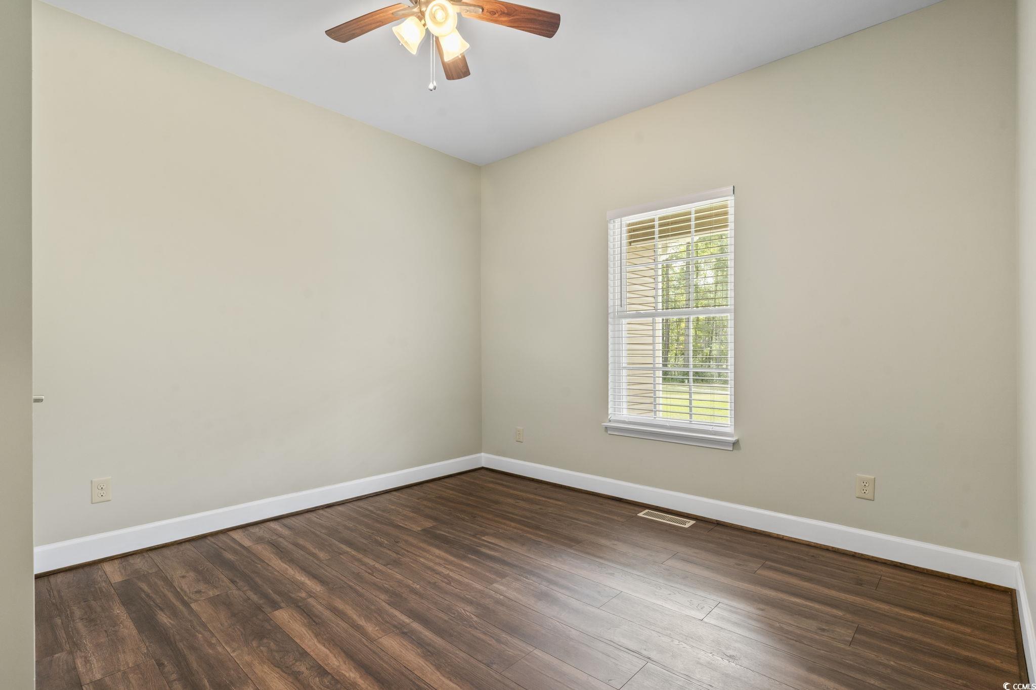 1585 Daisy Road Loris, SC 29569 - Photo 19 of 39 Unfurnished room with dark wood finished floors and ceiling fan