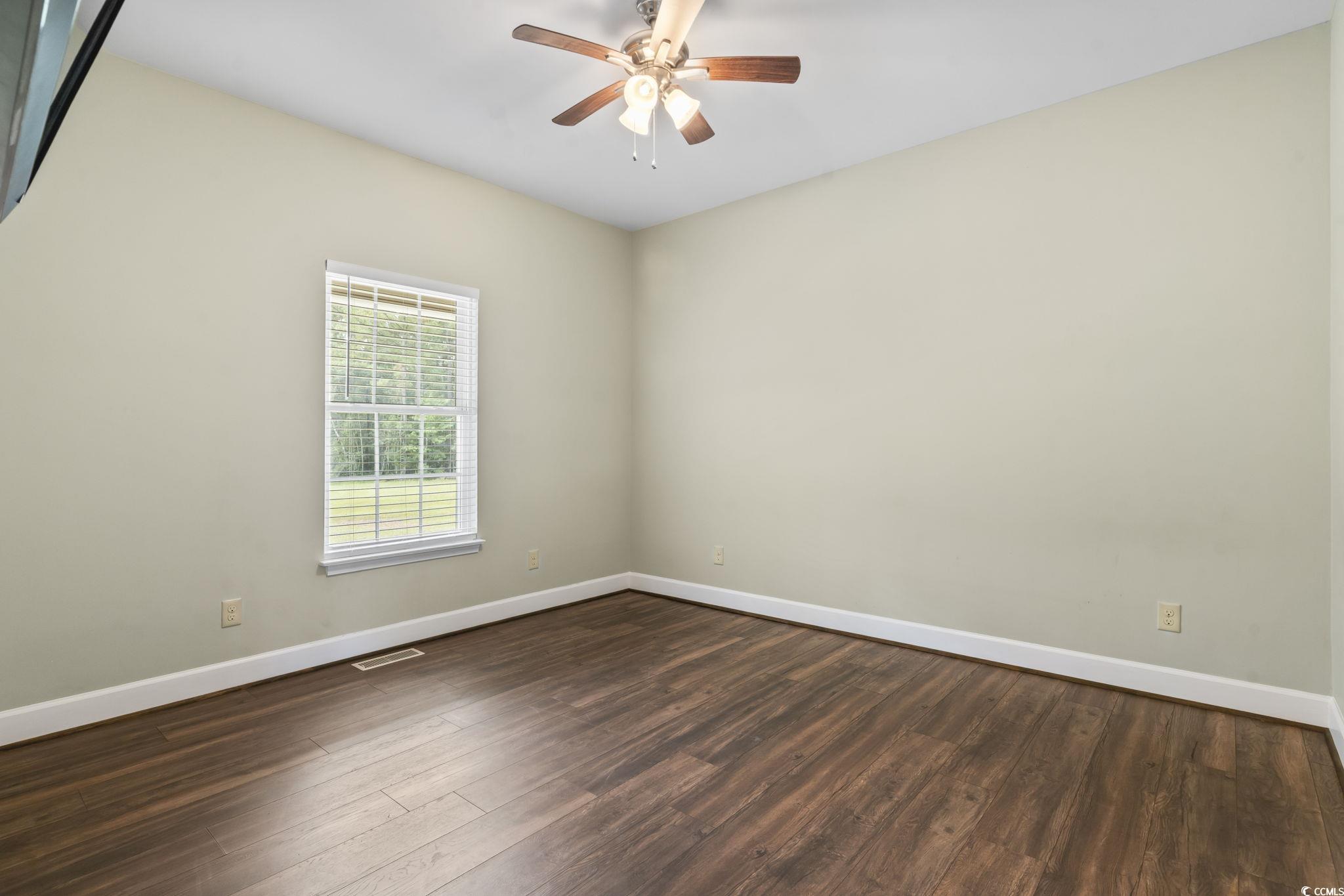 1585 Daisy Road Loris, SC 29569 - Photo 20 of 39 Unfurnished room with dark wood-style flooring and ceiling fan