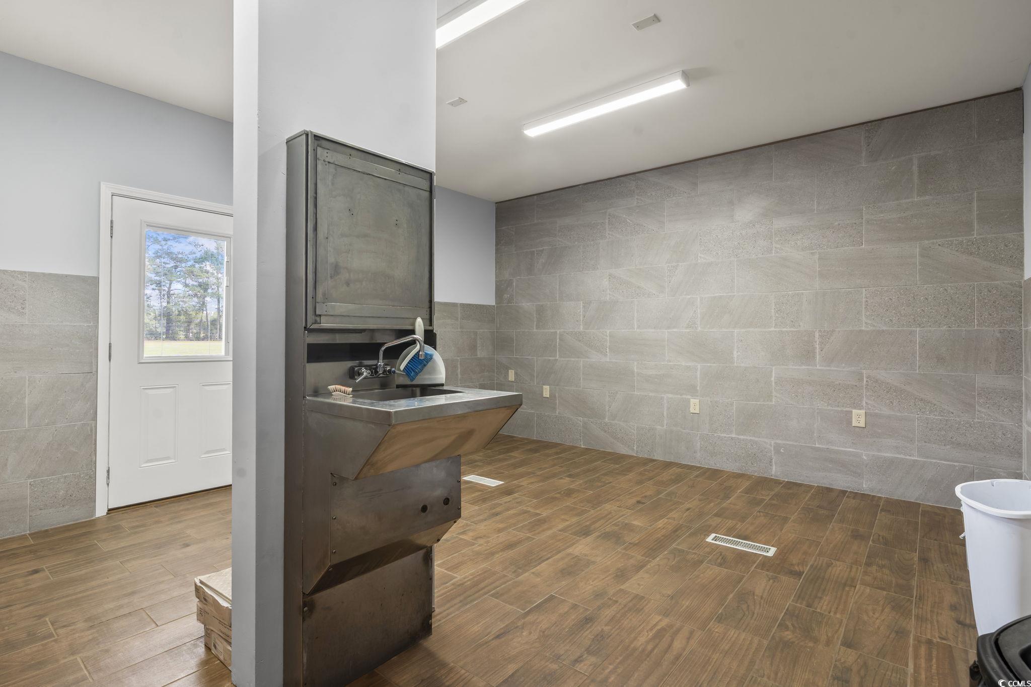 1585 Daisy Road Loris, SC 29569 - Photo 24 of 39 Full bath featuring tile walls, wood finish floors, and vanity