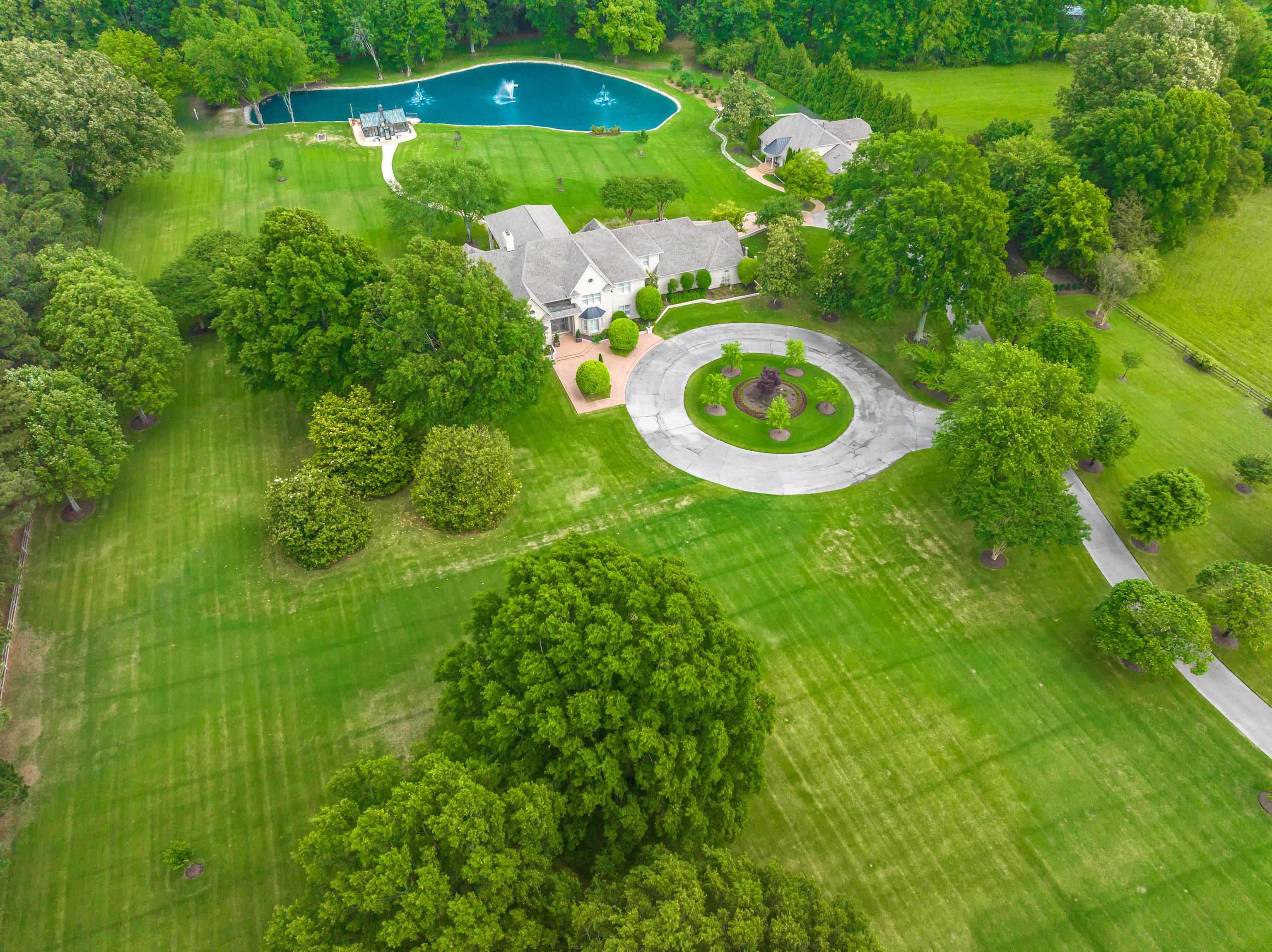 3044 Shea Road Collierville, TN 38017 - Photo 1 of 40 an aerial view of a house with a swimming pool and garden